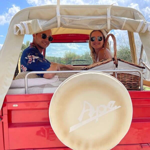 Couple sitting in a red tuk tuk and seen from the back of the tuk tuk