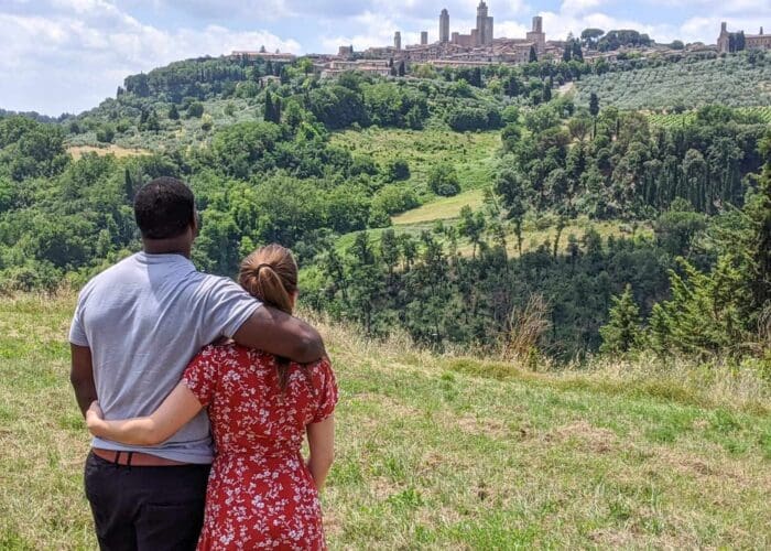 A couple looking at San Gimignano from far away