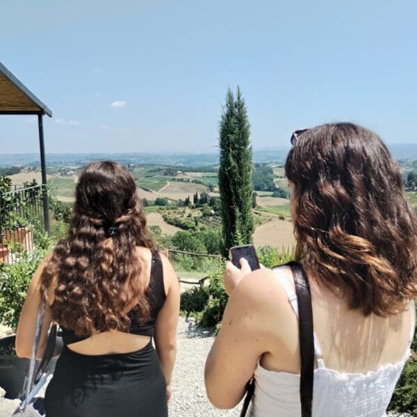 Two women walking away and towards a view of Chianti