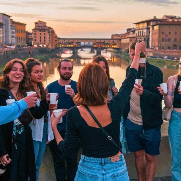 Tour guide cheering with wine to the group for a tipsy tour