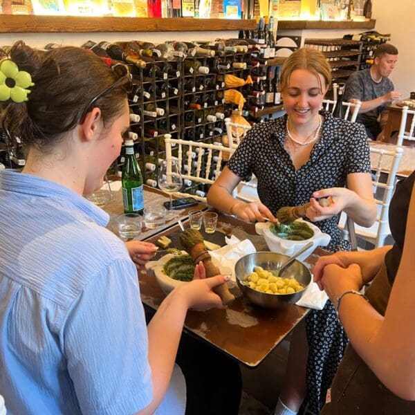 Two girls making pesto in a pesto making class